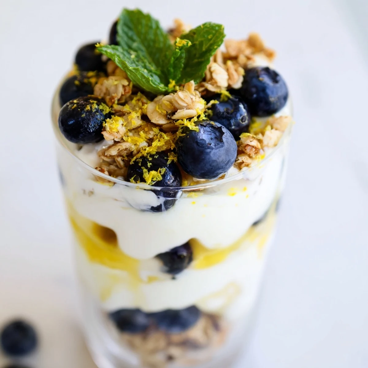 Layered Lemon Blueberry Yogurt Parfait showing fresh blueberries, granola crunch, and creamy textures.