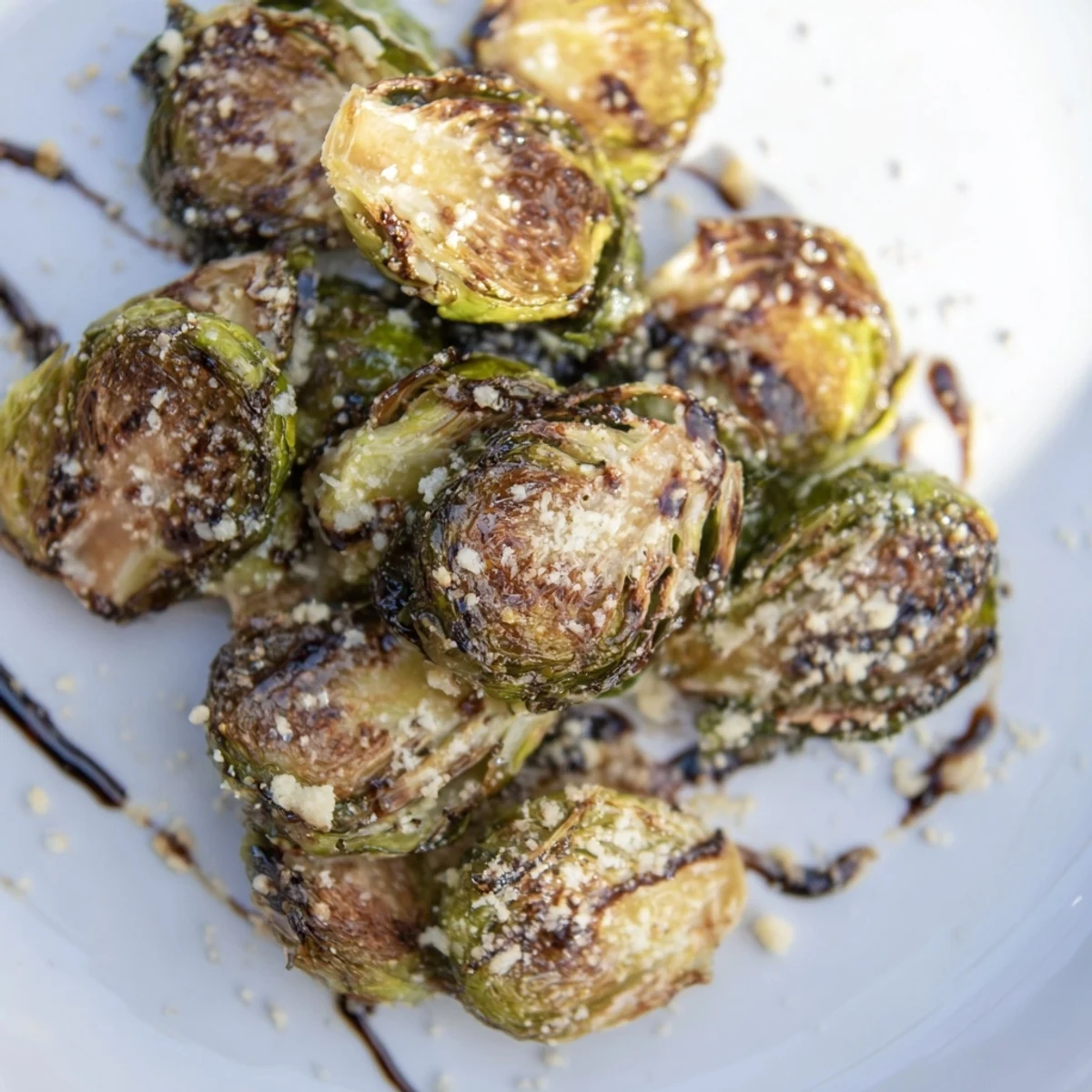 Caramelized Roasted Sprout Halves on a baking sheet, seasoned with garlic and olive oil for serving.