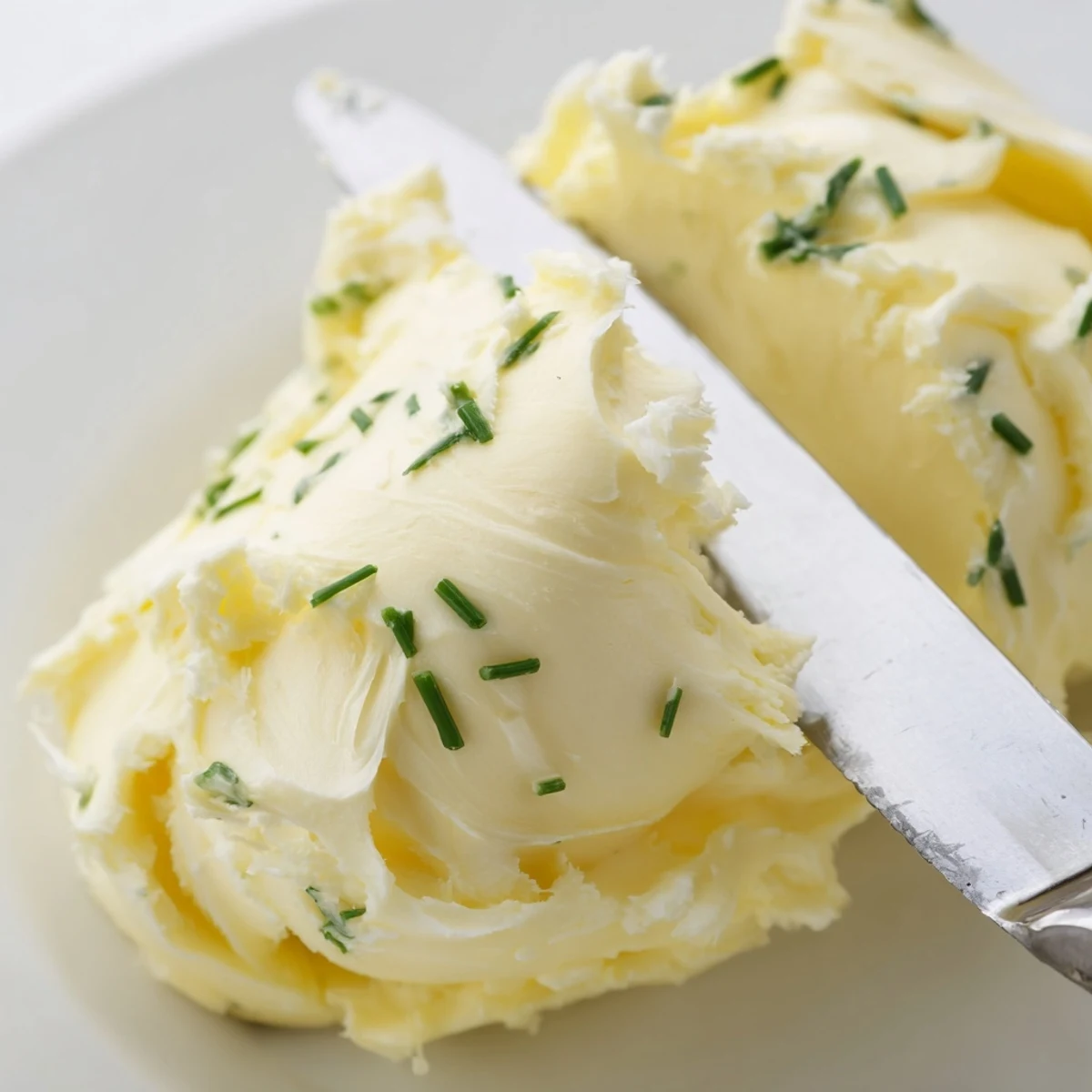 Homemade Creamy Salted Butter with a golden hue, perfect for spreading on warm fresh bread.