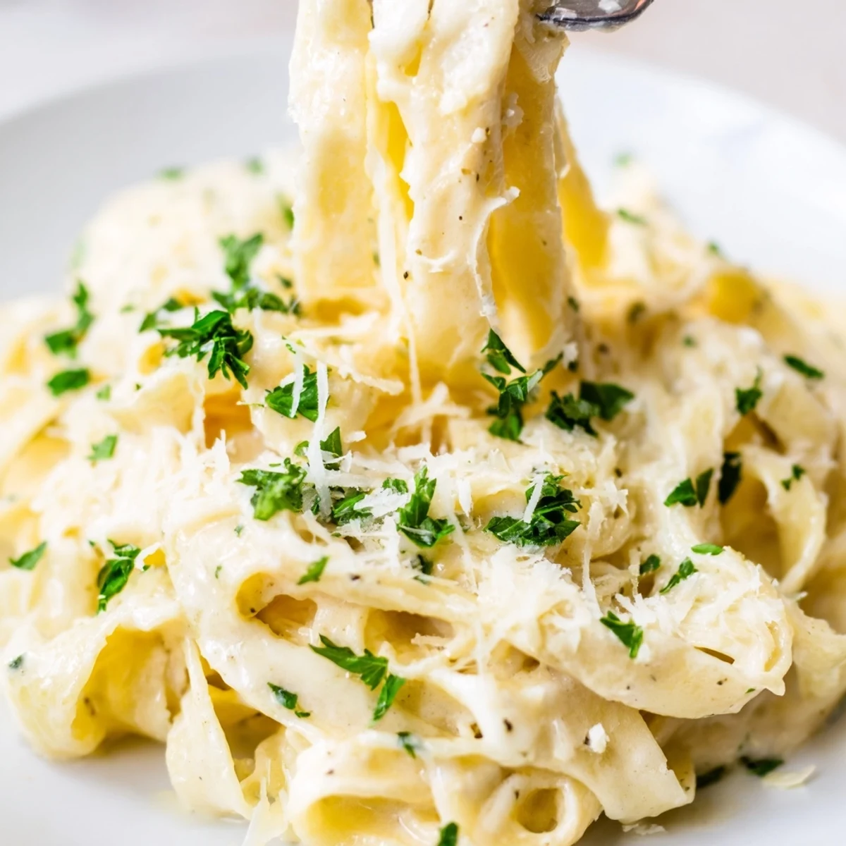 Creamy Dinner Pasta with velvety Parmesan sauce, tossed with penne and fresh parsley for a cozy meal.