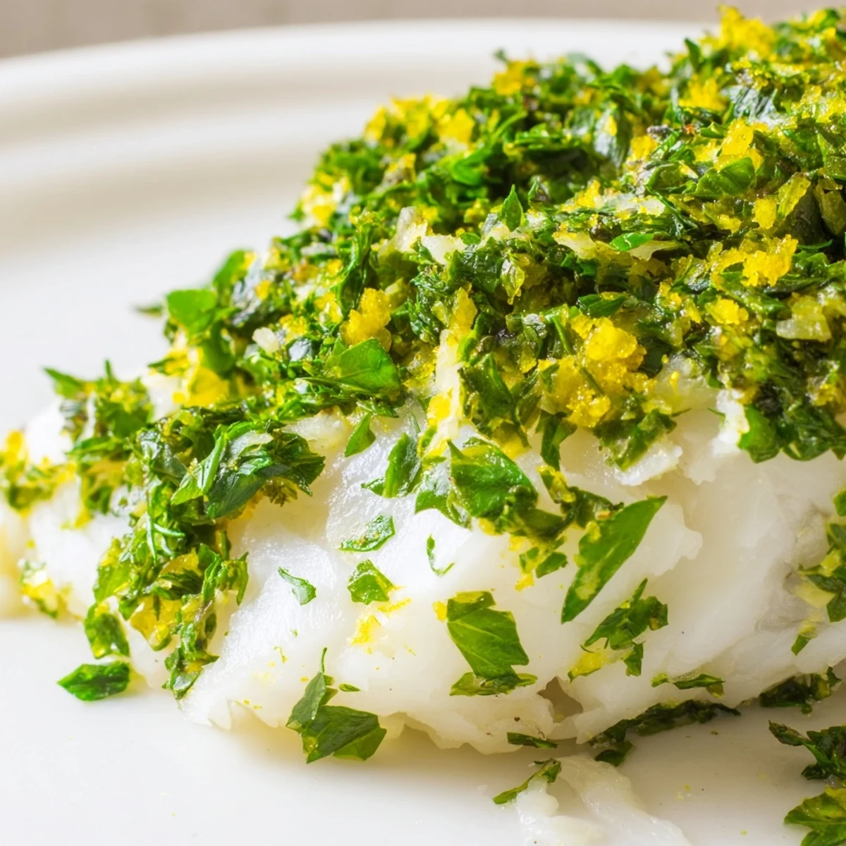 Flaky white fish garnished with chopped chives and dill, perfect for a healthy Mediterranean dinner.