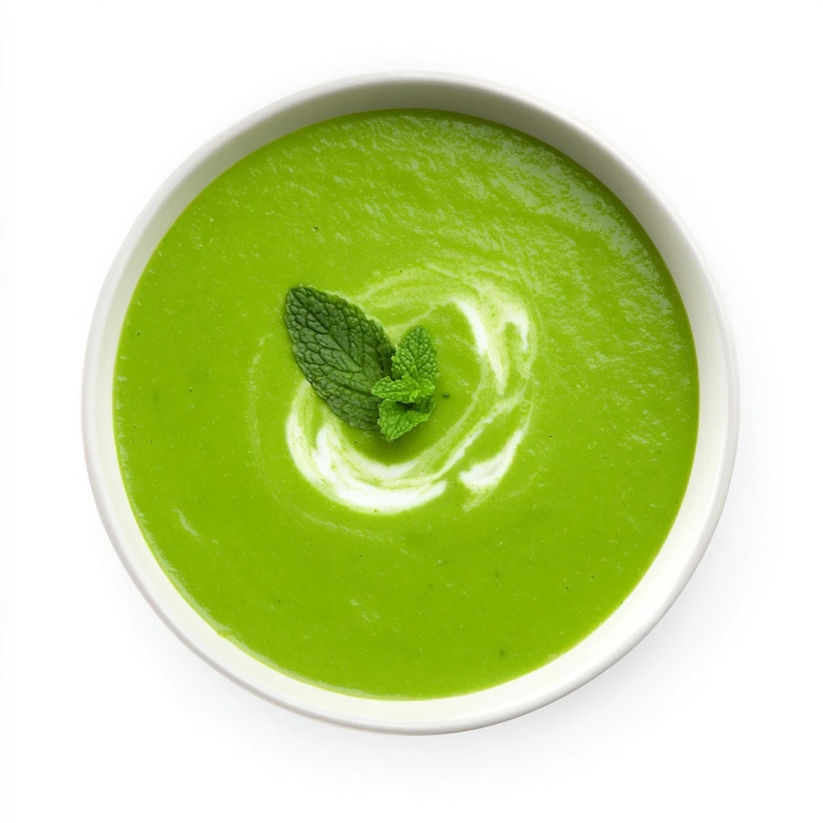 Creamy green pea and mint soup swirls with a drizzle of cream, accompanied by crusty bread for dipping.