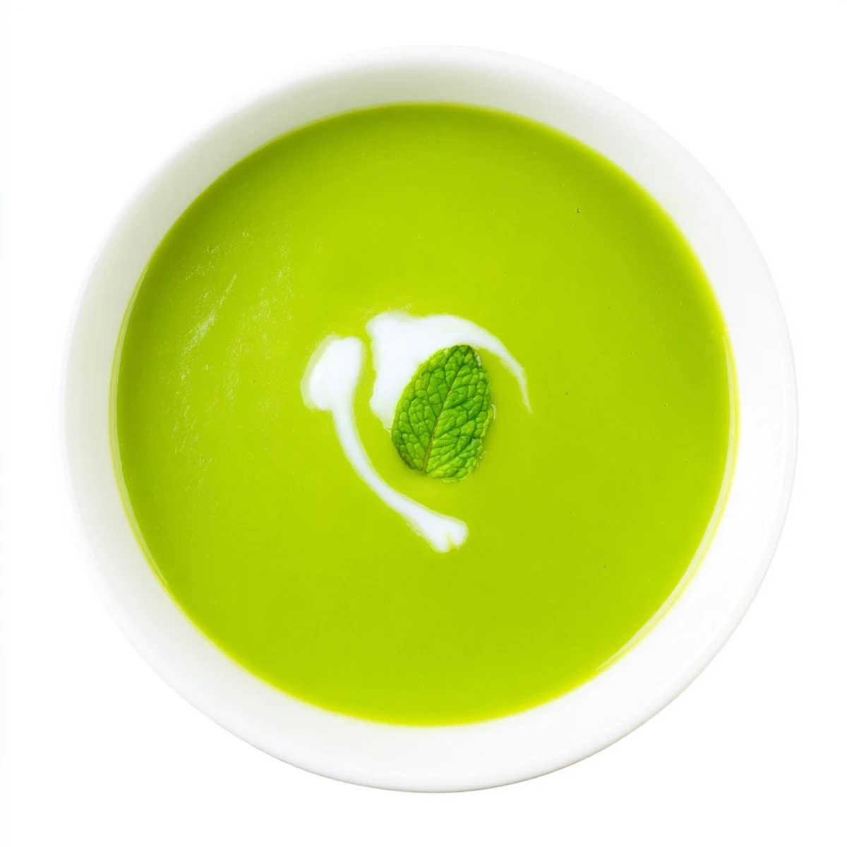 Close-up of glossy green pea and mint soup in a white bowl, highlighting its smooth, refreshing texture and bright color.