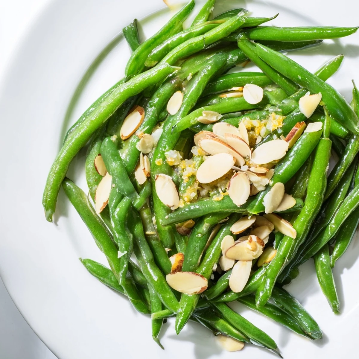 A close-up of vibrant Lemon Garlic Green Beans with Almonds, garnished with fresh lemon zest for a bright finish.