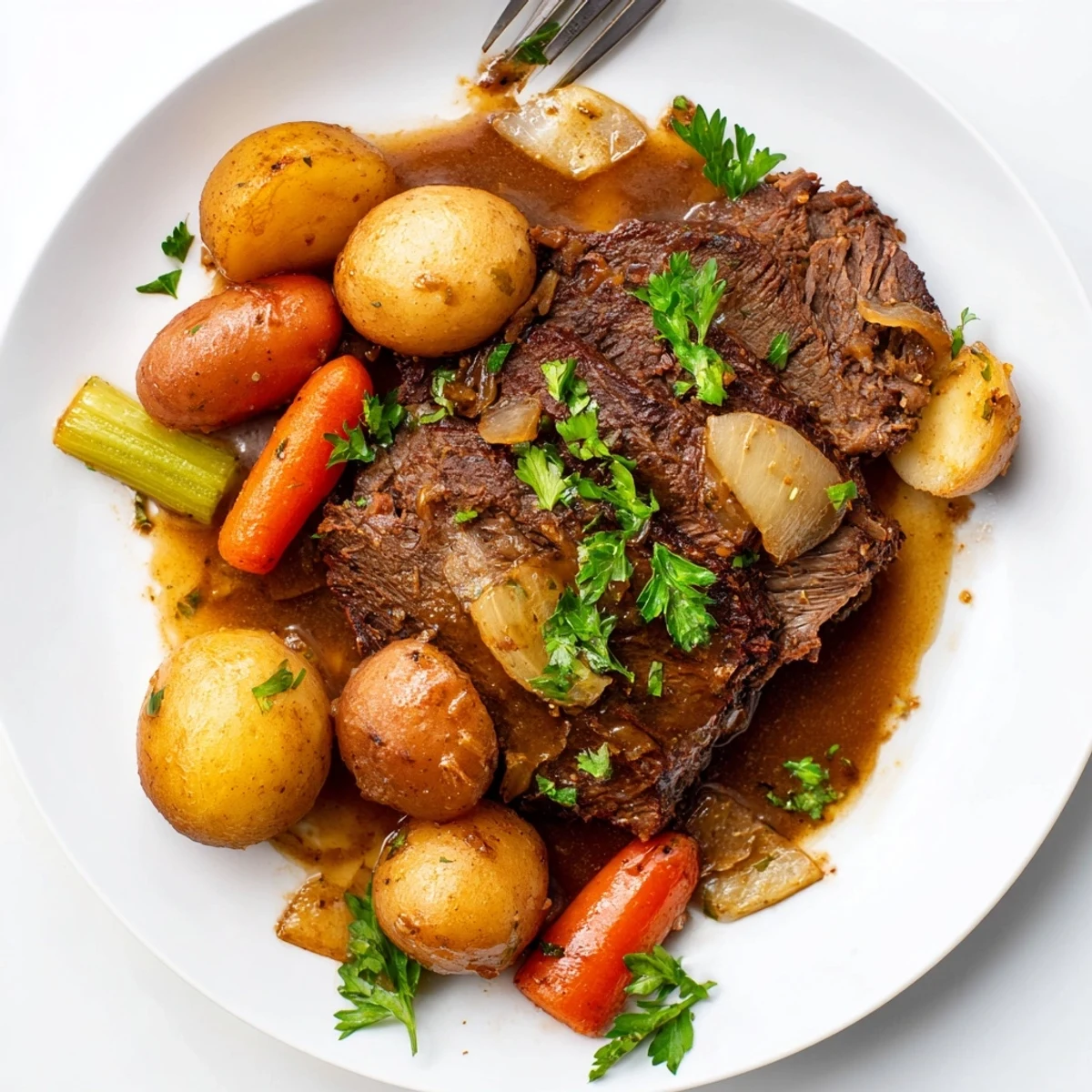 The tender, fall-apart Slow Cooker Beef Roast Dinner features juicy beef and colorful vegetables bathed in a rich savory gravy.