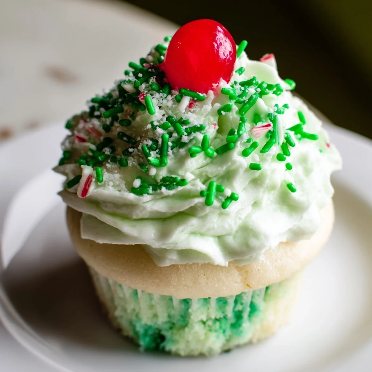 Moist Shamrock Shake Cupcakes topped with piped mint frosting, green sprinkles, and a cherry, perfect for St. Patrick’s Day.  