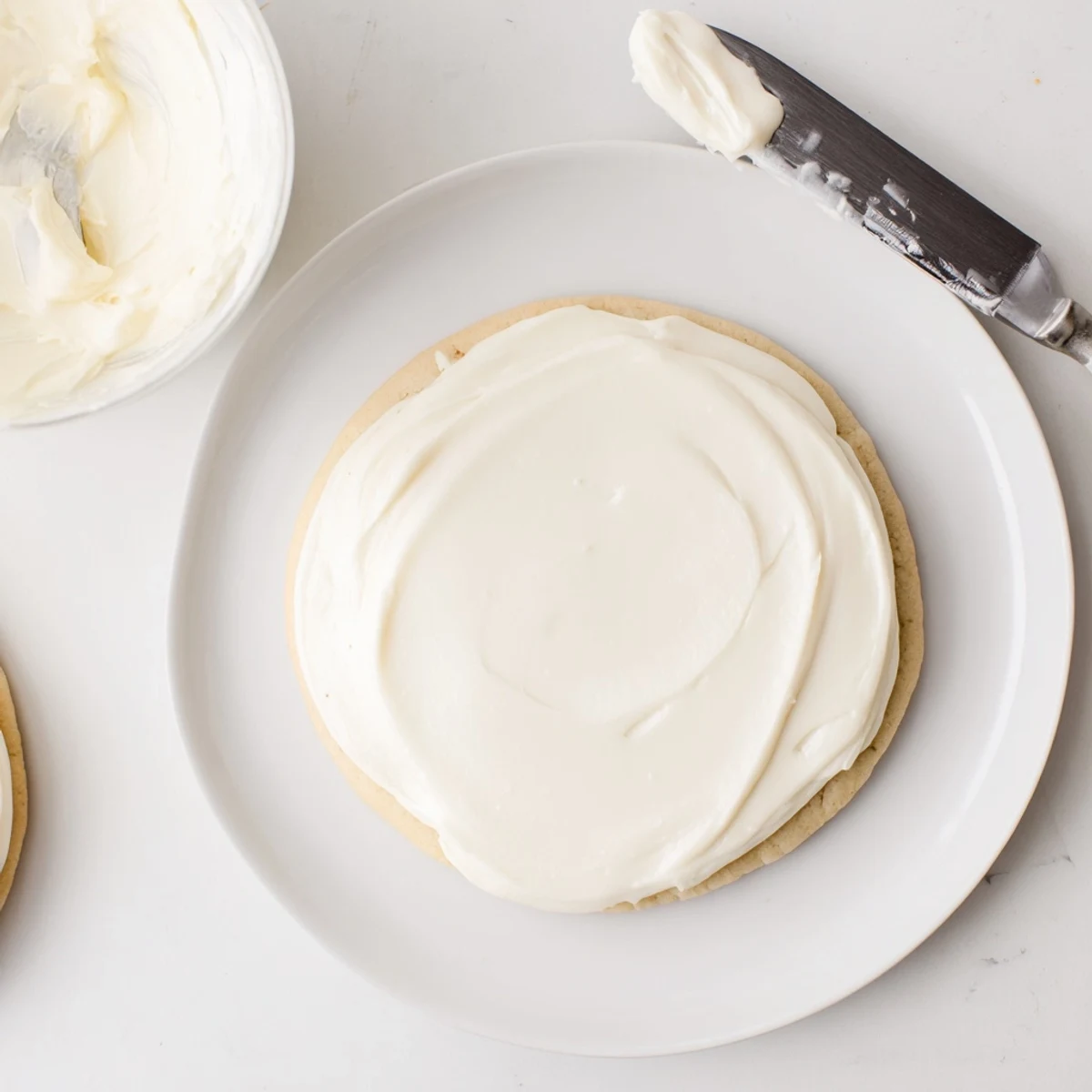 Softened butter and powdered sugar blend into Easy Sugar Cookie Frosting, ready to spread on holiday sugar cookies.