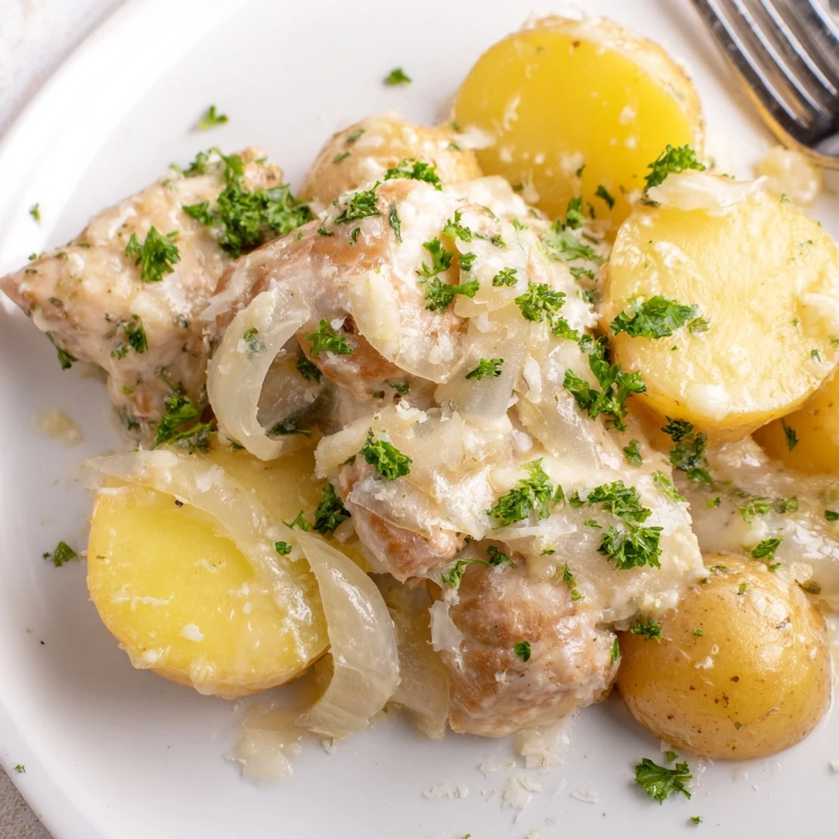Golden slow cooker garlic parmesan chicken with tender potatoes and melted cheese topping