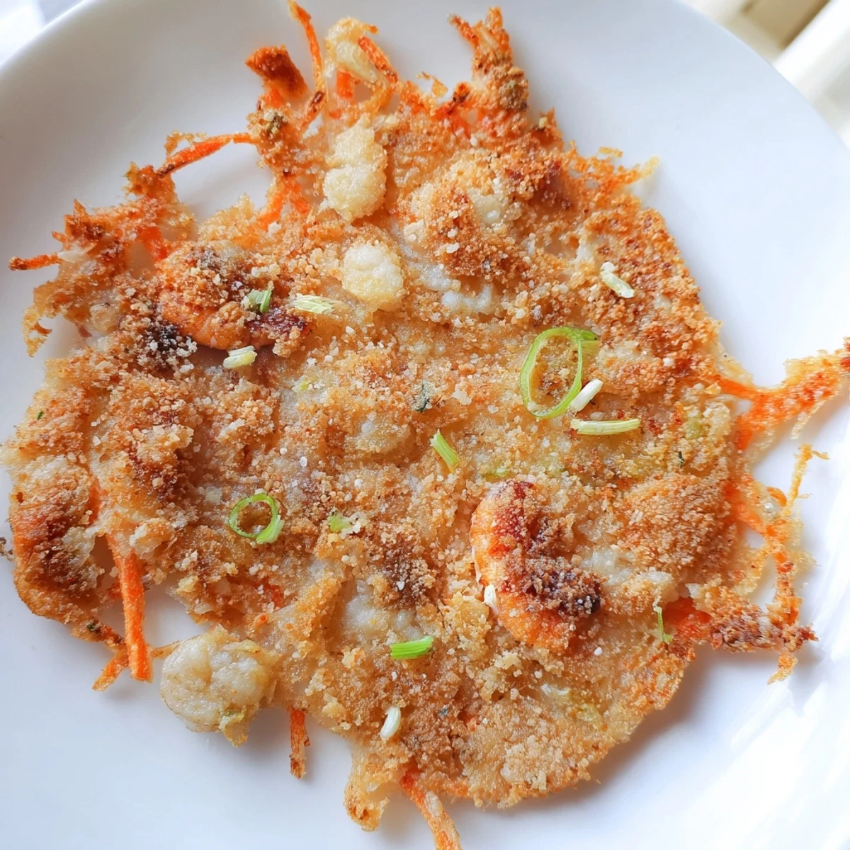 Ukoy Filipino shrimp fritters with julienned vegetables served alongside spiced vinegar dip