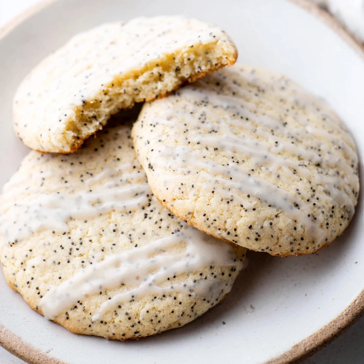 Chewy lemon poppy seed cookies with golden edges drizzled in sweet citrus glaze