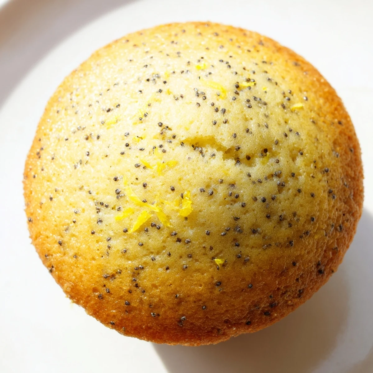Golden lemon poppy seed muffins with domed tops fresh from the oven on a wire cooling rack