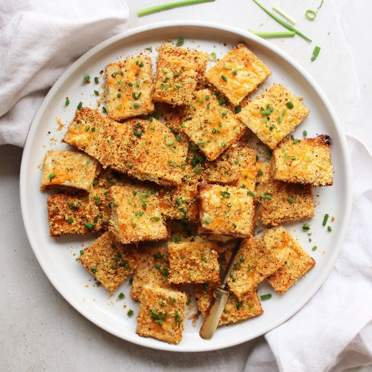 Warm sharp cheddar herb snacks with paprika specks served beside a creamy dip