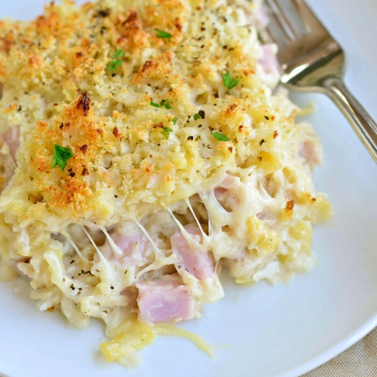 Golden, bubbling Chicken Cordon Bleu Casserole with melted Swiss and crunchy Panko