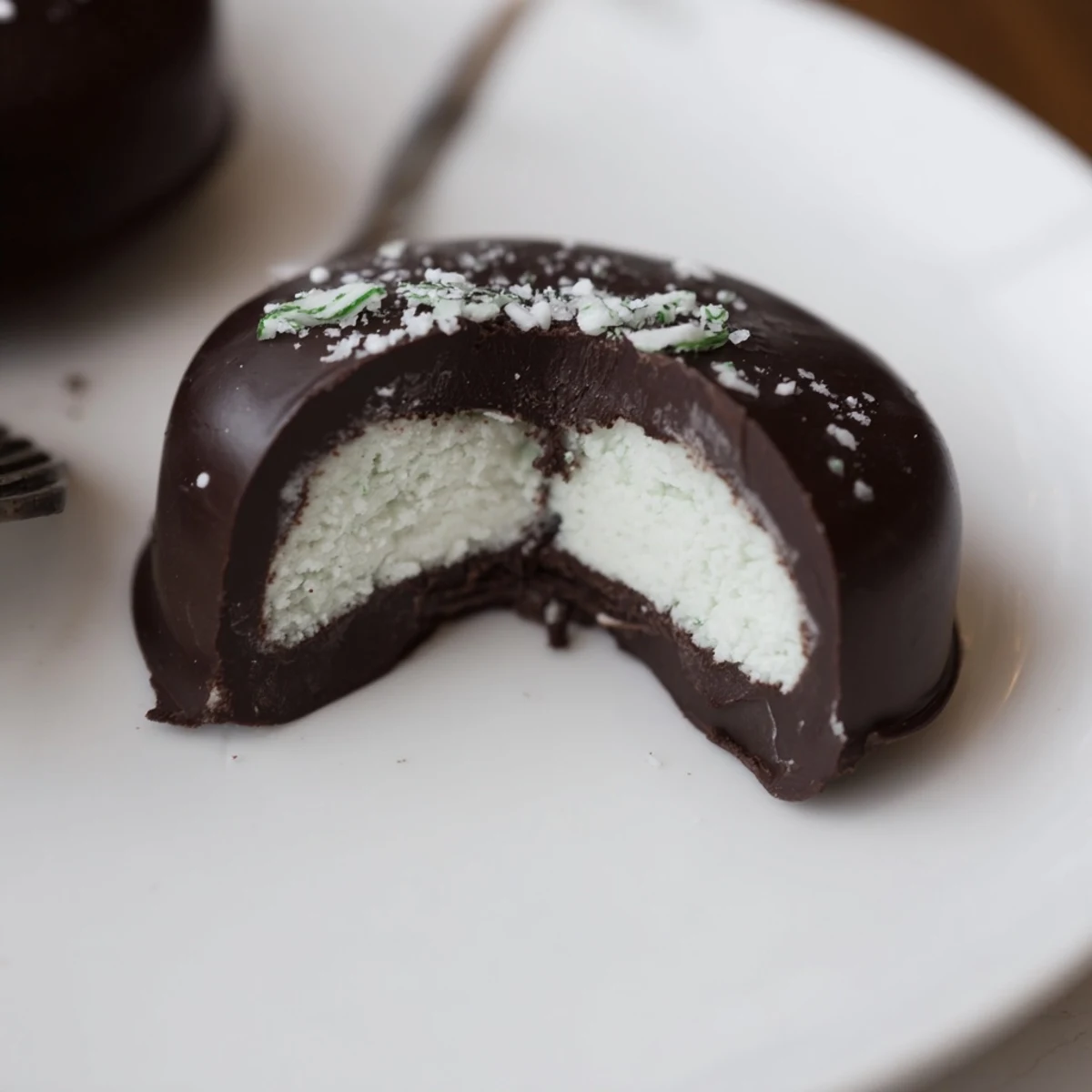 Peppermint Patties arranged on parchment, glossy dark chocolate and crushed candy