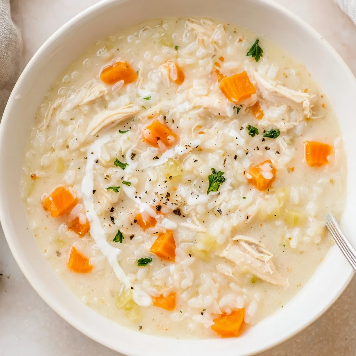 Creamy Chicken Rice Soup steaming in bowl, tender chicken and cozy aroma