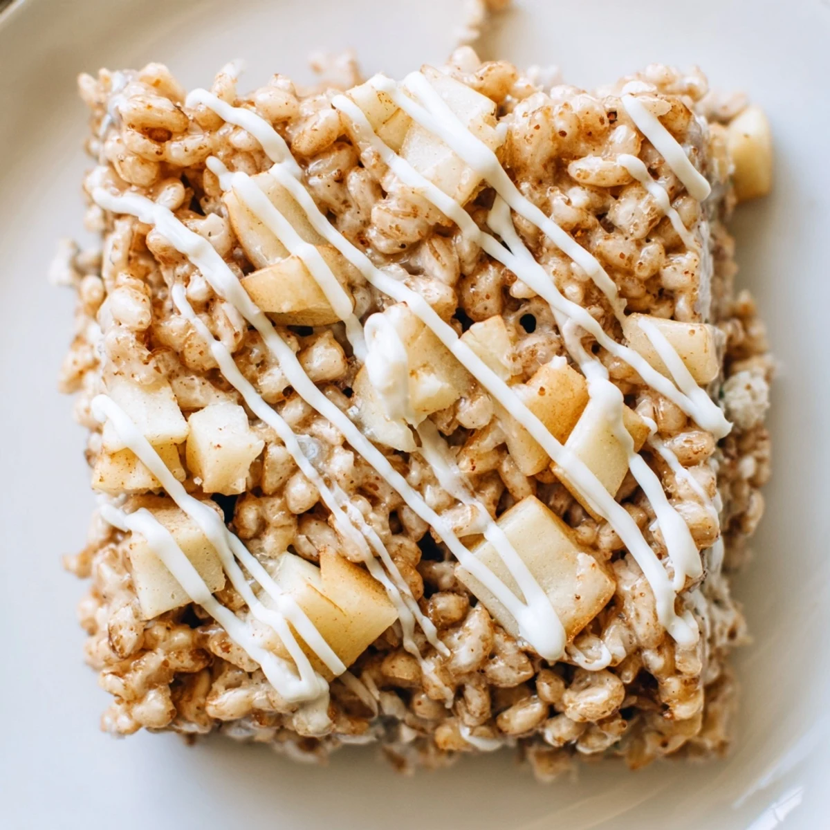 Chewy marshmallow and crispy rice cereal bars topped with warm spiced caramelized apple pieces