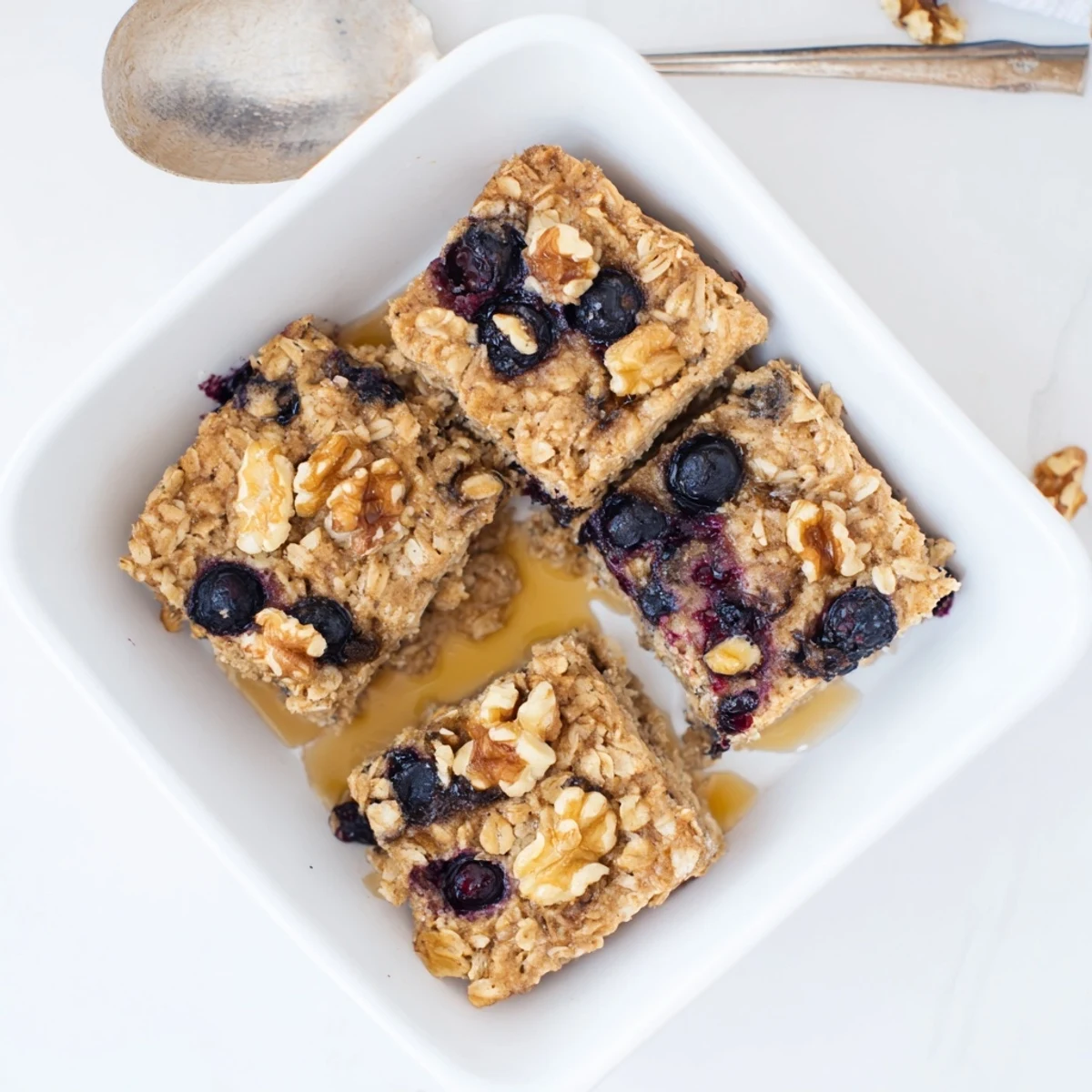 Golden brown baked oatmeal with fresh blueberries and a sprinkle of cinnamon on top