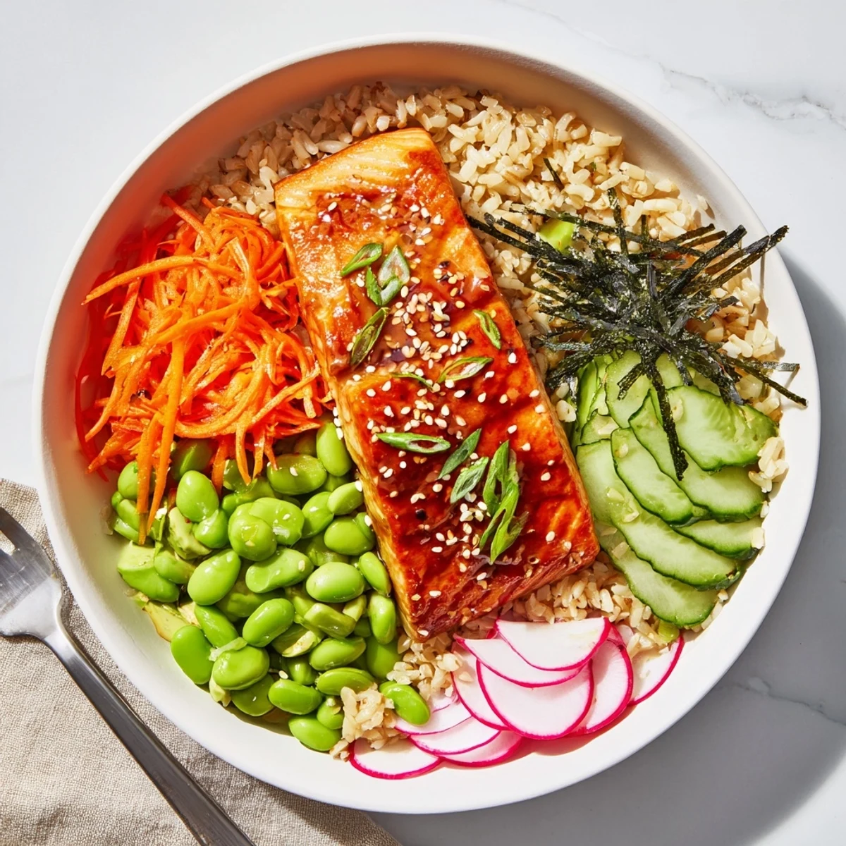 Hearty miso salmon grain bowl drizzled with tangy dressing and sprinkled with nori
