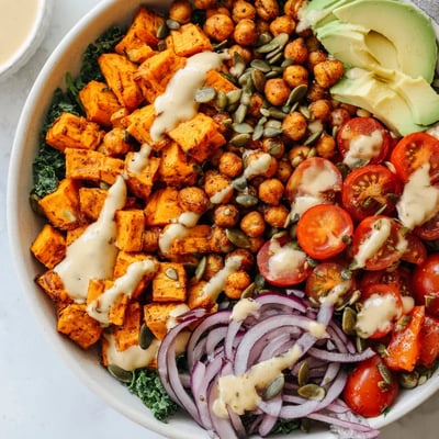 Crispy spiced chickpeas and tender sweet potatoes in a vibrant nourishing grain-free bowl